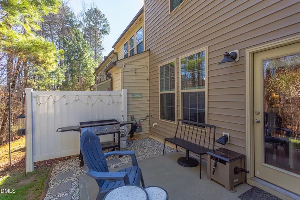 a view of a patio with couple of chairs and a fire pit
