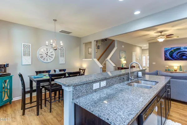 a kitchen with a table a sink and cabinets