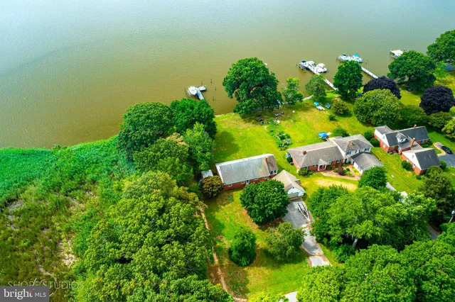an aerial view of a house with a yard
