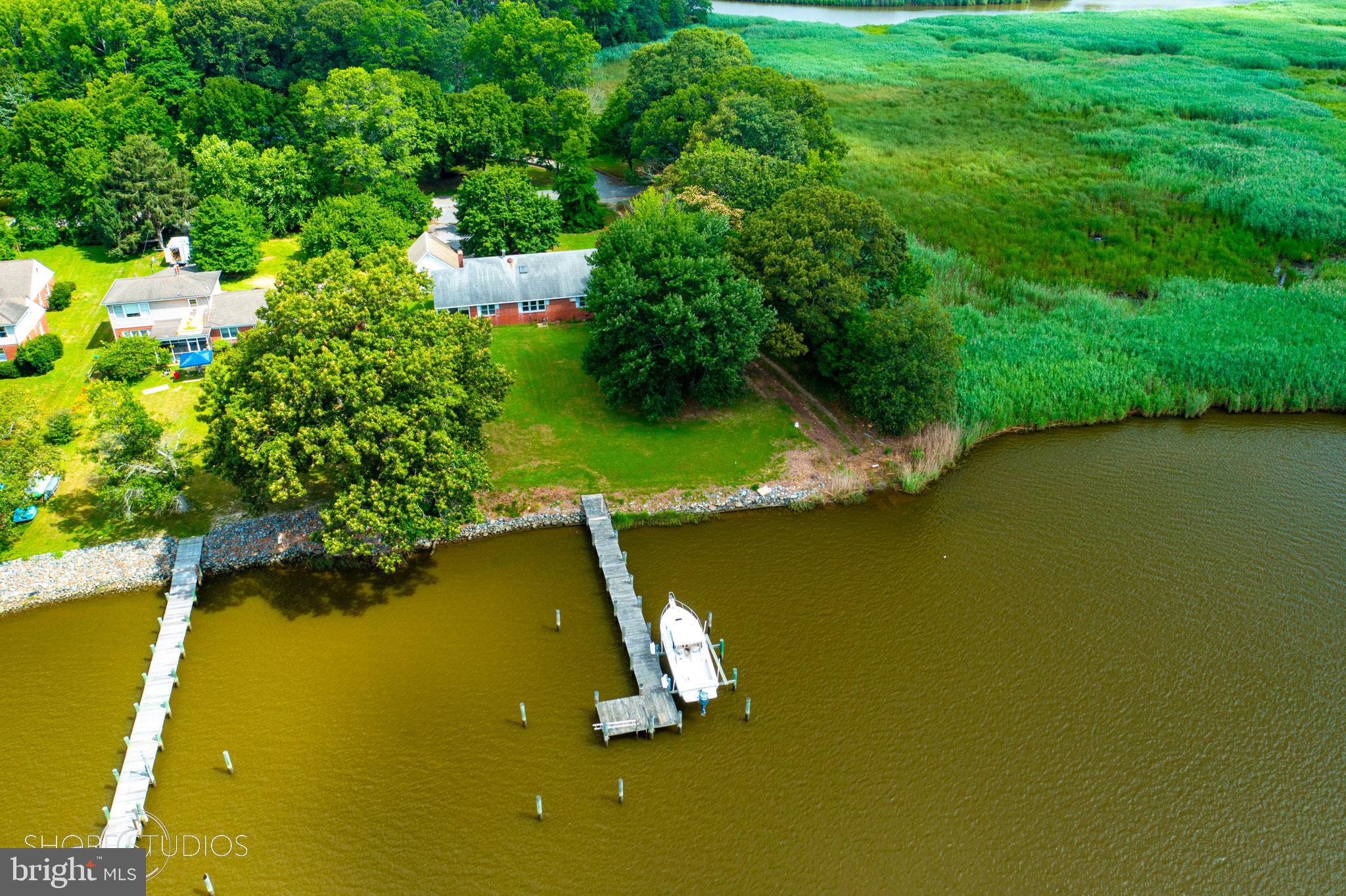 26933 Mallard Road Chestertown, MD 21620 - Photo 2 of 15 a view of a lake with a yard and large trees