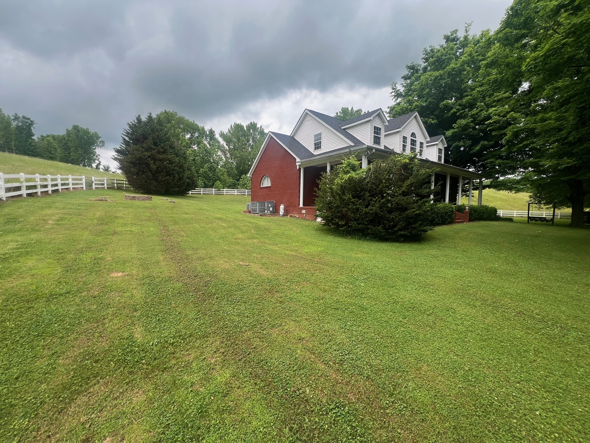 1400 Sumac Road Pulaski, TN 38478 - Photo 38 of 49 a yellow and red house sitting in the middle of a field