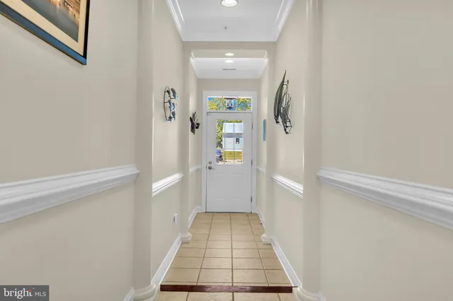 a view of a hallway with stairs and wooden floor