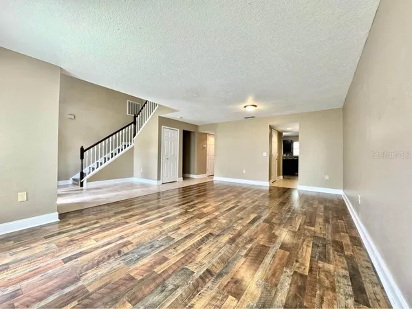 a view of an empty room and wooden floor