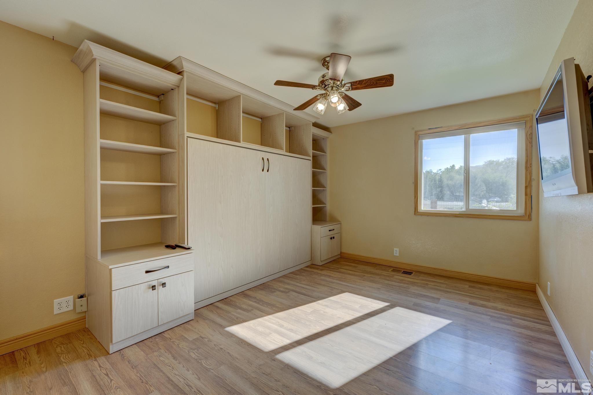 14640 Toll Road Reno, NV 89521 - Photo 21 of 40 a view of an empty room with a window and wooden floor