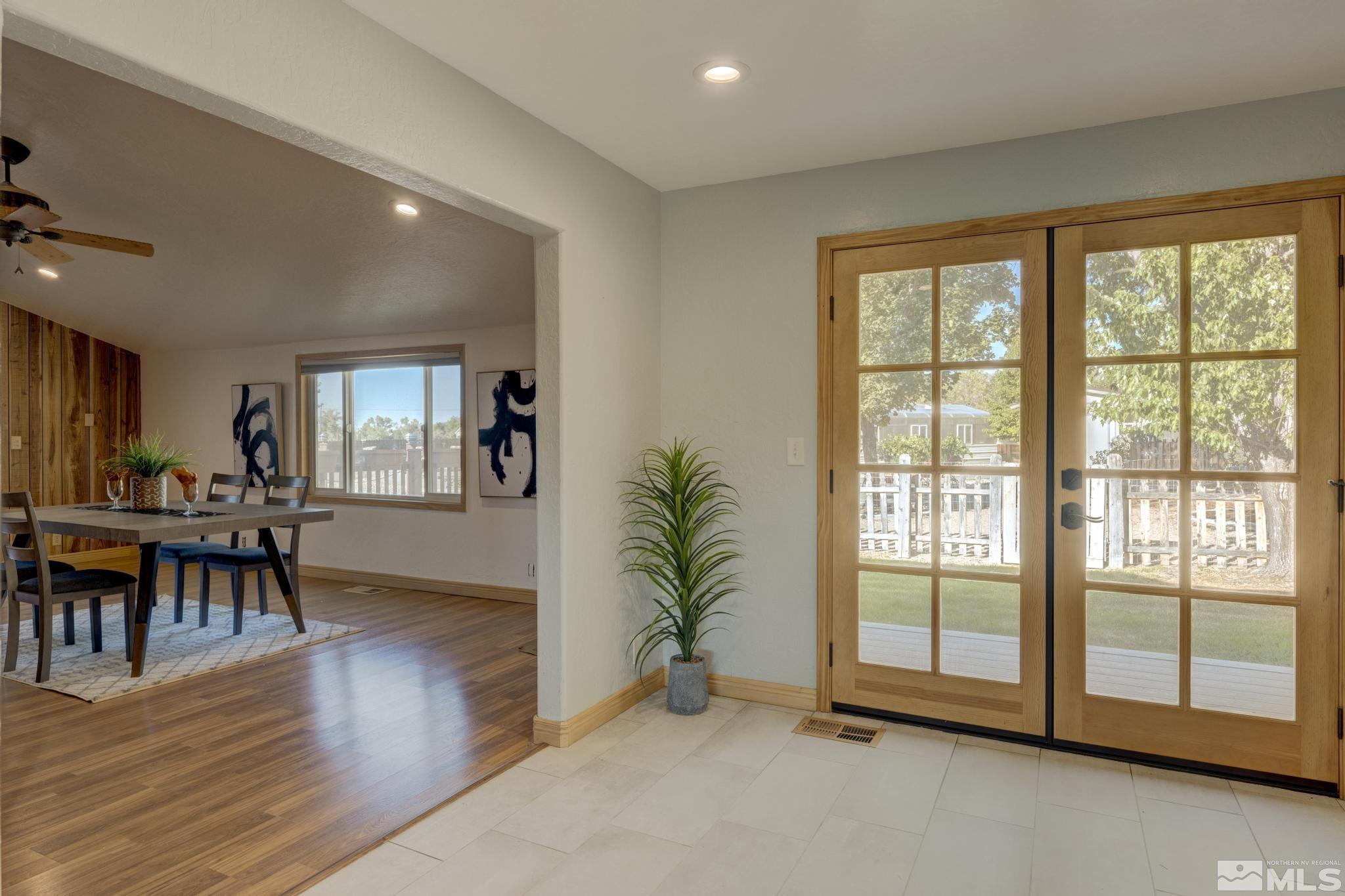 14640 Toll Road Reno, NV 89521 - Photo 9 of 40 a view of an empty room with wooden floor and a floor to ceiling window