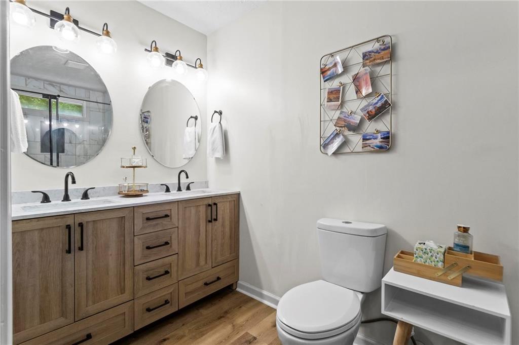 6971 Recreation Lane Acworth, GA 30102 - Photo 14 of 23 a bathroom with a toilet a sink and mirror