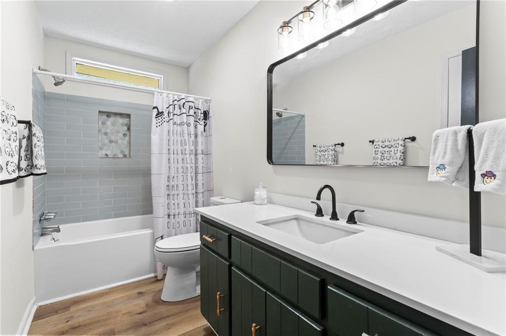 6971 Recreation Lane Acworth, GA 30102 - Photo 17 of 23 a bathroom with a sink a toilet and shower