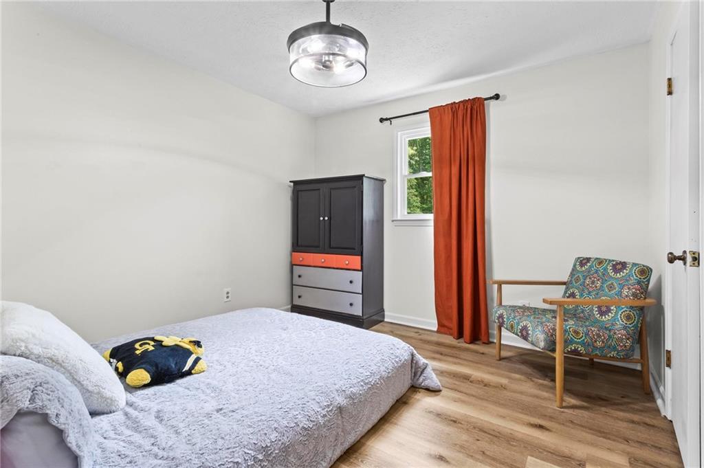 6971 Recreation Lane Acworth, GA 30102 - Photo 18 of 23 a bedroom with a bed and a chandelier