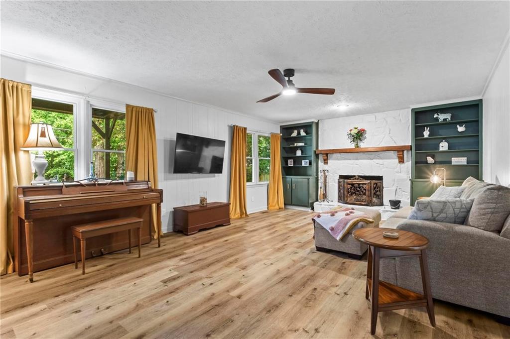 6971 Recreation Lane Acworth, GA 30102 - Photo 5 of 23 a living room with furniture a flat screen tv and a fireplace