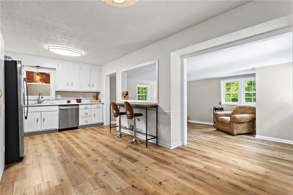 6971 Recreation Lane Acworth, GA 30102 - Photo 7 of 23 a living room with furniture and a kitchen