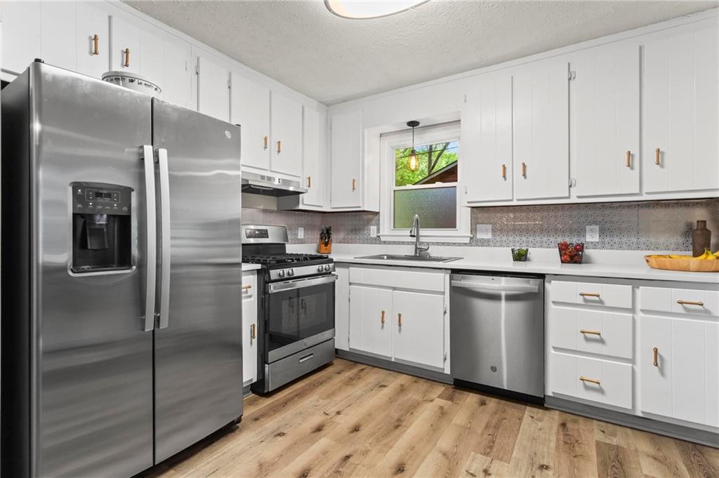 6971 Recreation Lane Acworth, GA 30102 - Photo 9 of 23 a kitchen with cabinets stainless steel appliances and a window