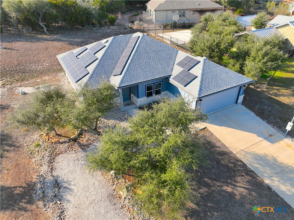 an aerial view of a house with a yard