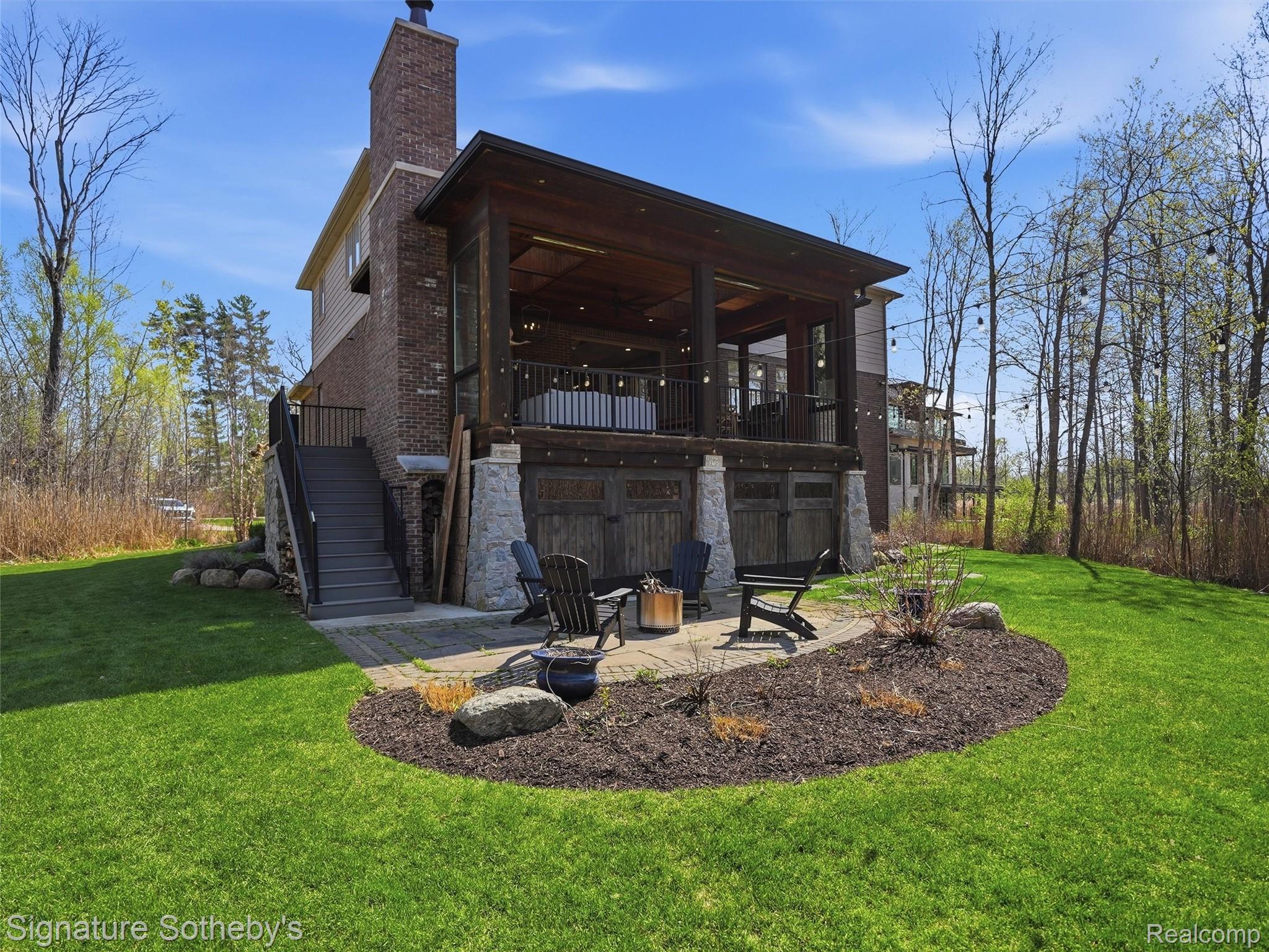 1595 Carriage Way Rochester, MI 48307 - Photo 21 of 78 Rear view of house featuring a lawn, a patio, a fire pit, a chimney, and brick siding