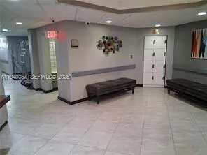 a living room with furniture gym equipment and a window