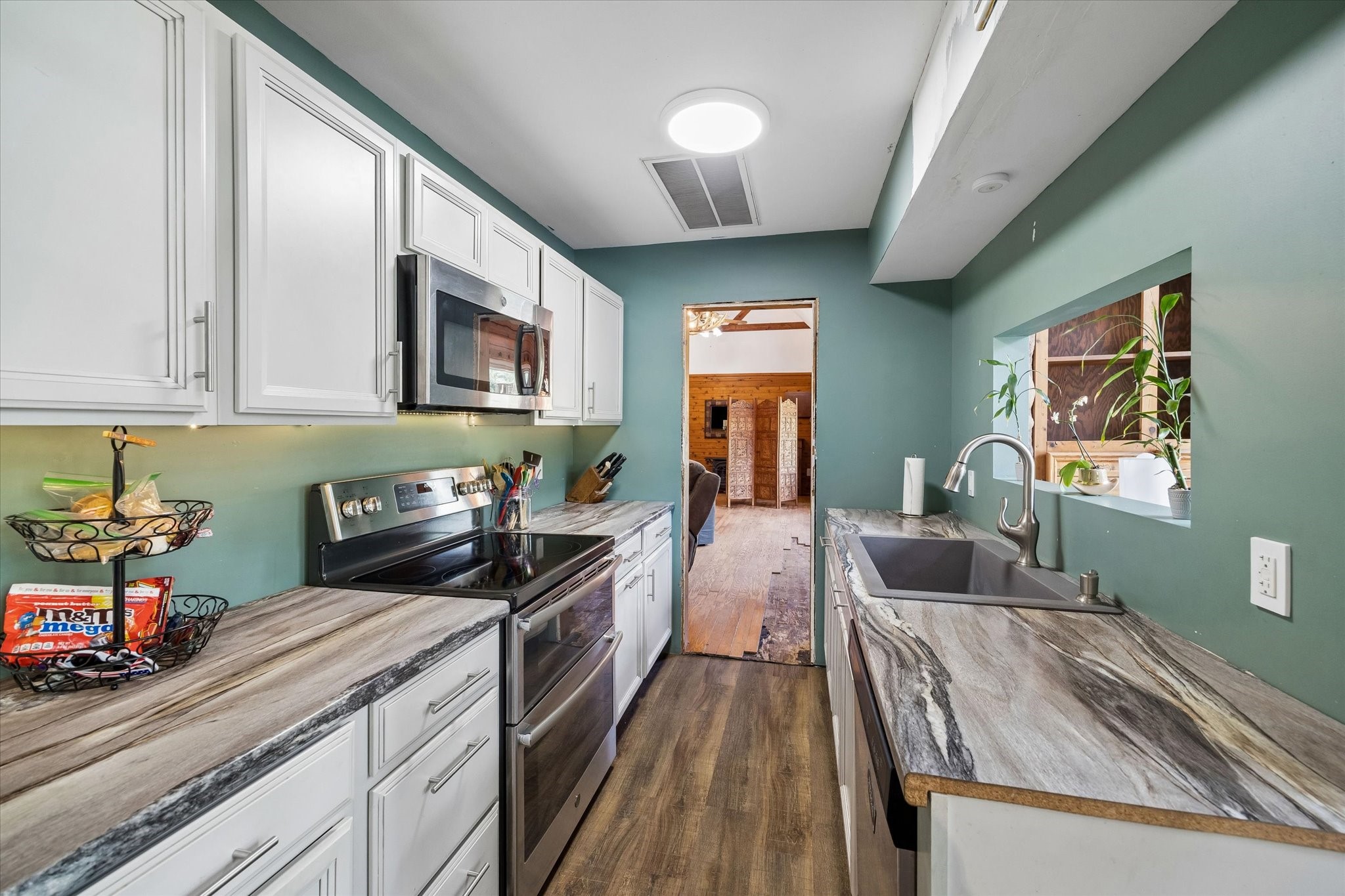 438 Havard Road, Unit 2 Huffman, TX 77336 - Photo 6 of 10 a kitchen with sink stove and cabinets