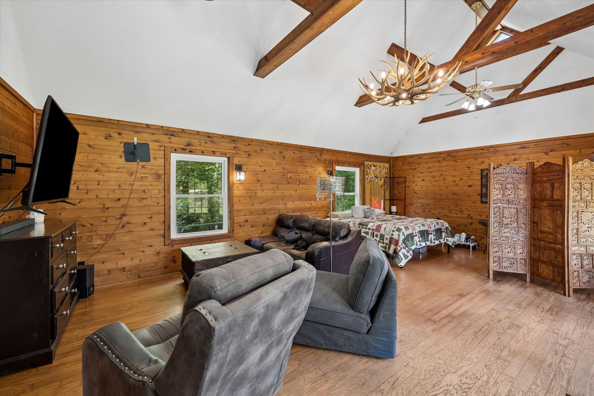 438 Havard Road, Unit 2 Huffman, TX 77336 - Photo 7 of 10 a living room with furniture a flat screen tv and a floor to ceiling window