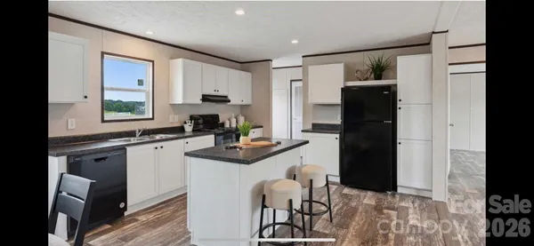 a kitchen with a refrigerator and a stove top oven