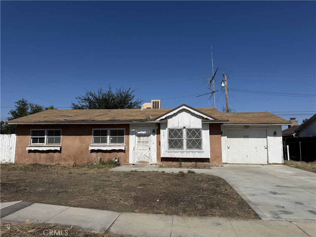a front view of a house with a garage and yard