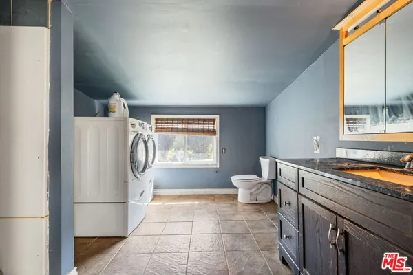 a kitchen with a refrigerator and a sink