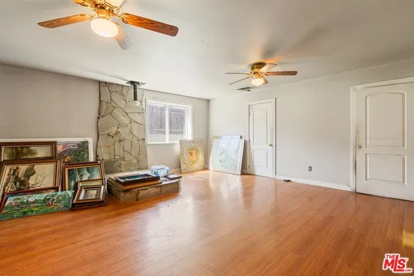 a view of livingroom with hardwood floor and a ceiling fan