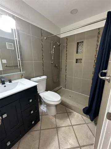 a bathroom with a toilet sink and shower