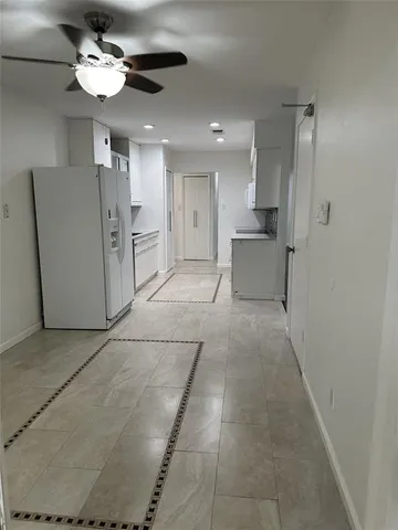 a view of a hallway with chandelier