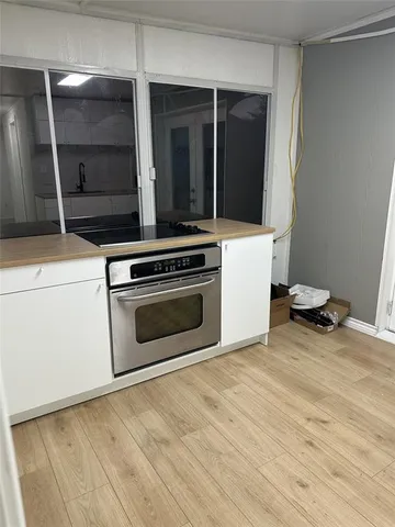 a kitchen with a stove and a refrigerator