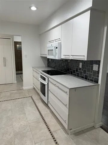a kitchen with a stove and a sink