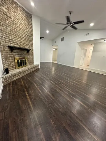 wooden floor in an empty room with a fireplace