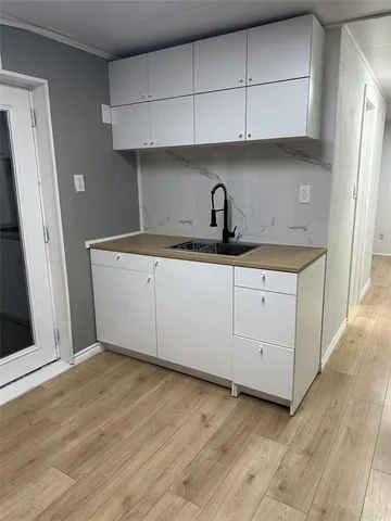 a kitchen with a sink and cabinets