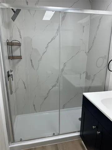 a bathroom with a bathtub and a shower