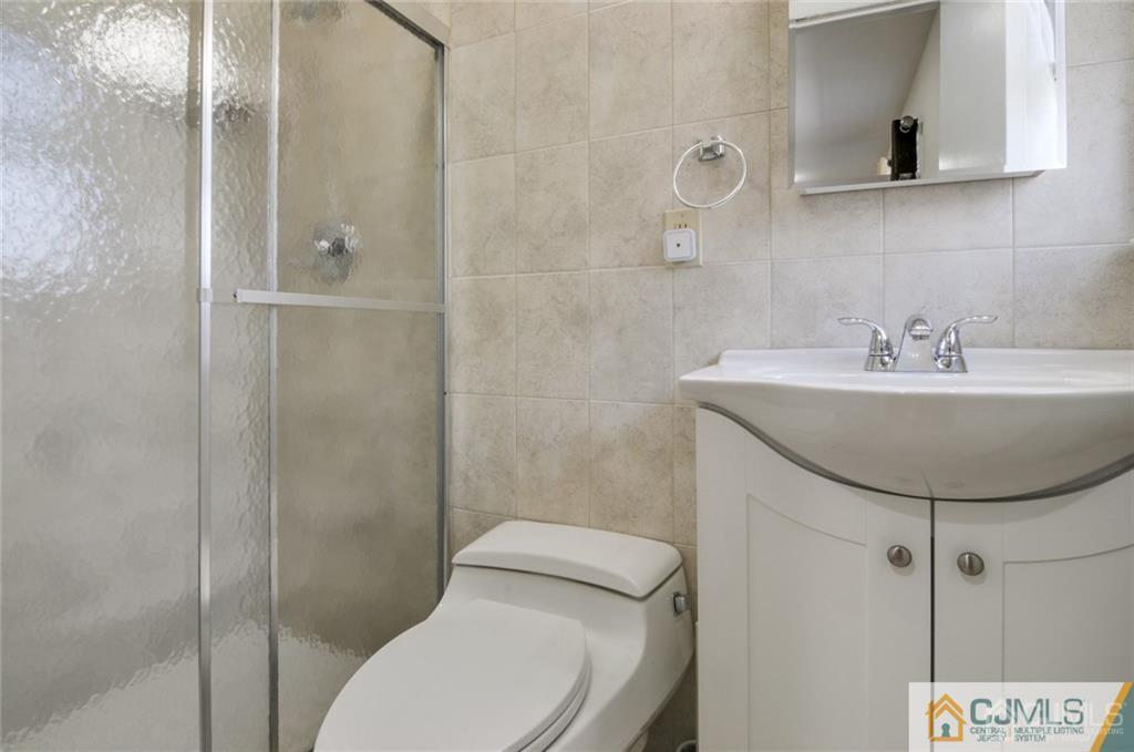 62 Gage Road East Brunswick, NJ 08816 - Photo 15 of 23 a bathroom with a sink a toilet and shower