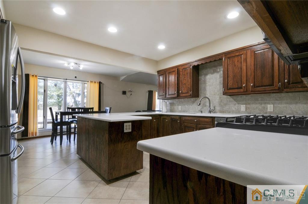 62 Gage Road East Brunswick, NJ 08816 - Photo 4 of 23 a kitchen with a sink a microwave and cabinets