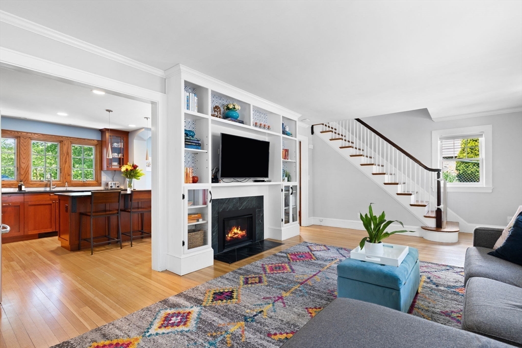 80 Baxter Street Melrose, MA 02176 - Photo 5 of 23 a living room with furniture a flat screen tv and a fireplace