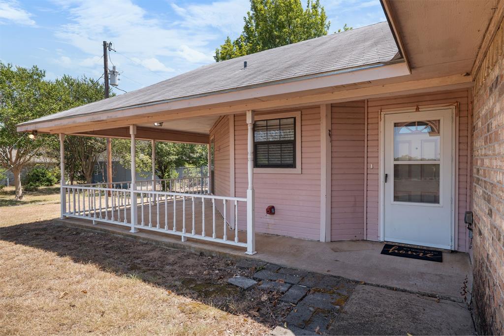 162 Warren Road Lorena, TX 76655 - Photo 37 of 39 Covered front porch with white railings and an exterior door with a glass insert