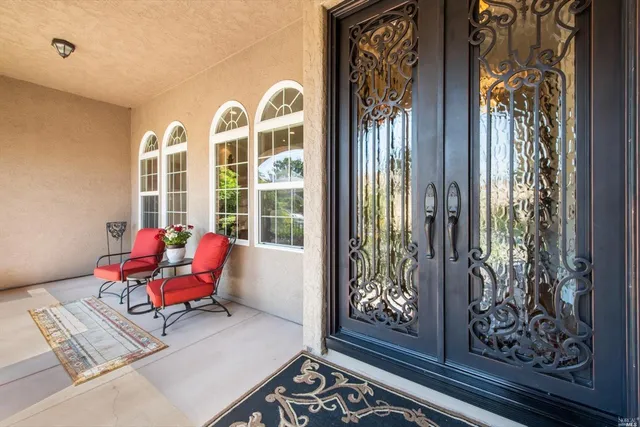 a dining room with furniture a chandelier and wooden floor