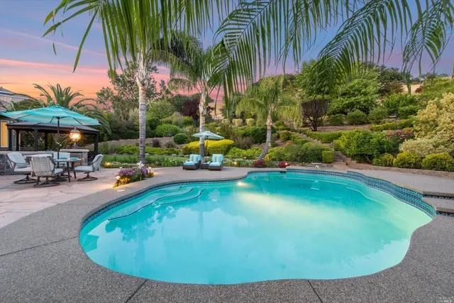 an outdoor space with swimming pool and furniture