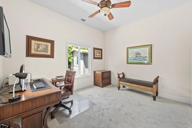 a backyard of a house with table and chairs