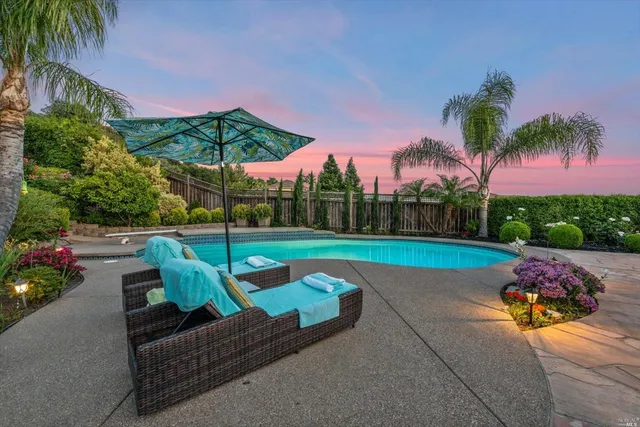 a view of a swimming pool with a lounge chairs
