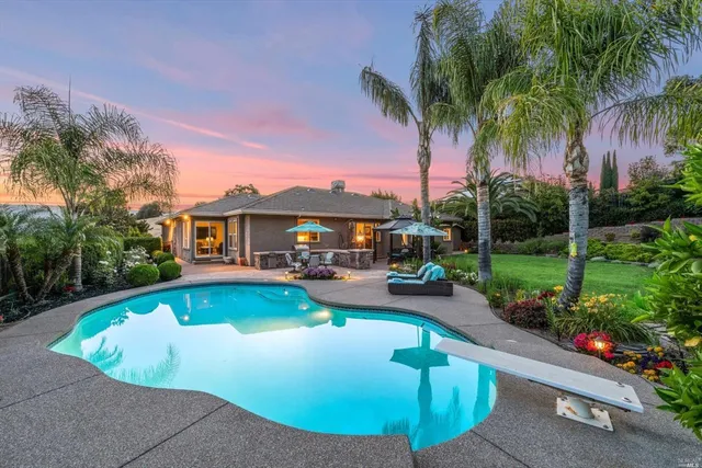 a front view of a house with a garden and yard