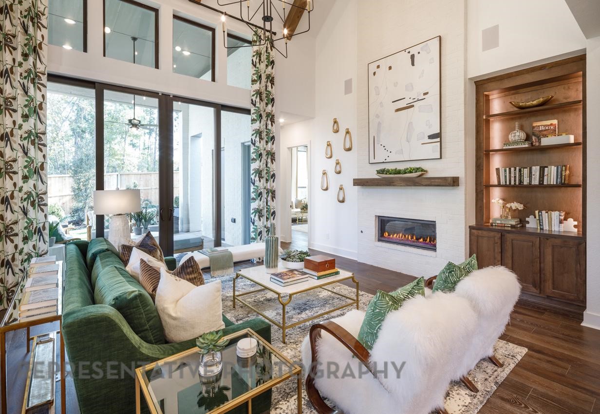 5402 Verona Ridge Drive Fulshear, TX 77406 - Photo 15 of 49 a living room with furniture a fireplace and a table