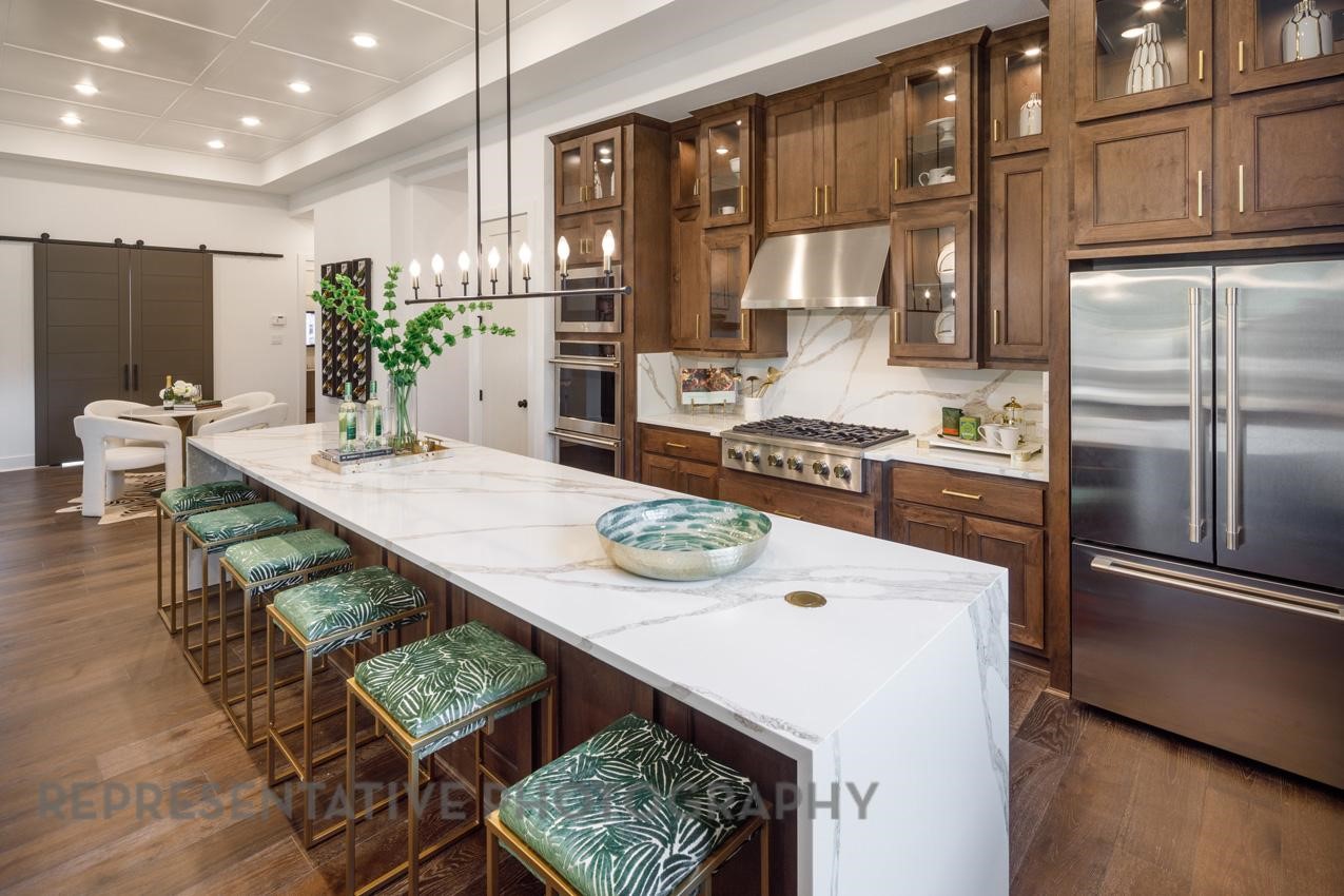 5402 Verona Ridge Drive Fulshear, TX 77406 - Photo 2 of 49 a kitchen with stainless steel appliances granite countertop a sink refrigerator and cabinets