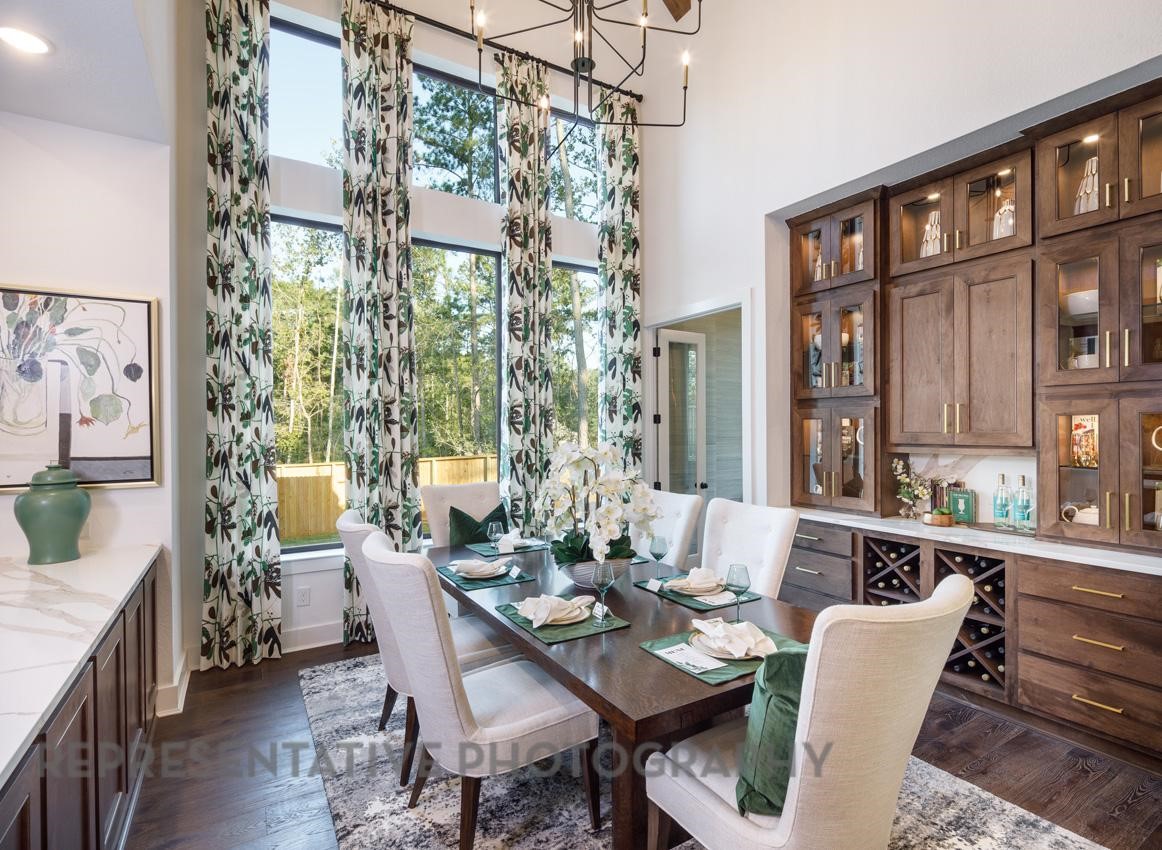 5402 Verona Ridge Drive Fulshear, TX 77406 - Photo 36 of 49 a view of a dining room with furniture a chandelier and wooden floor