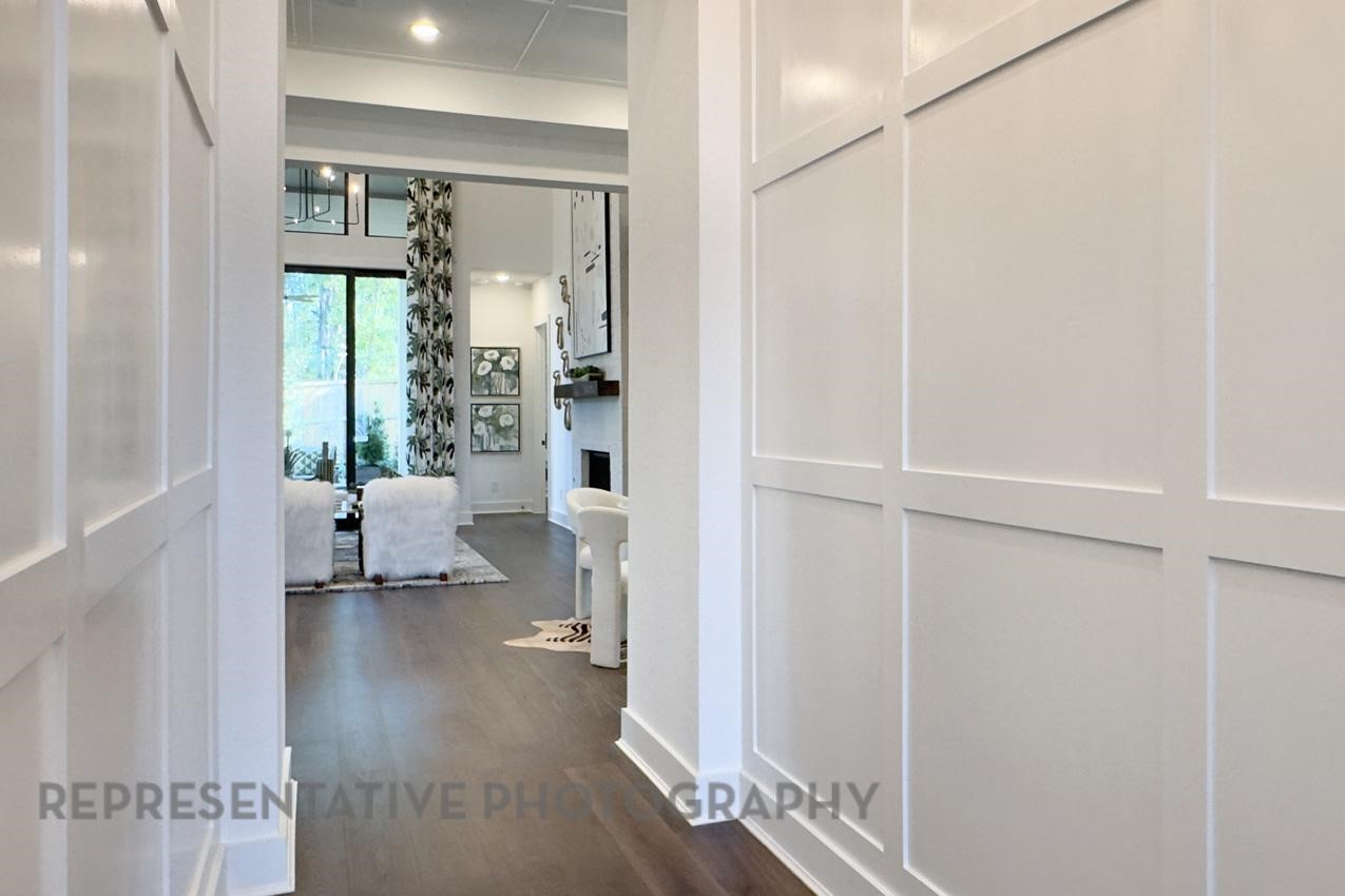 5402 Verona Ridge Drive Fulshear, TX 77406 - Photo 39 of 49 a living room with furniture and a floor to ceiling window