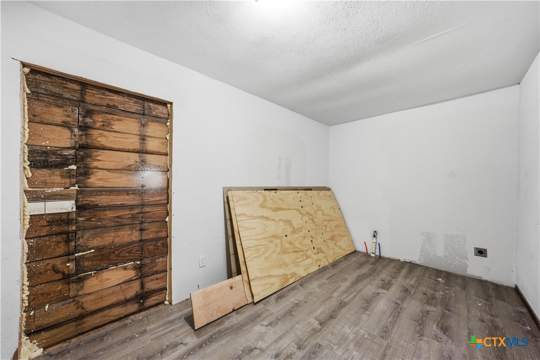 1780 Moores Mill Road Temple, TX 76504 - Photo 13 of 17 a view of an empty room and wooden floor