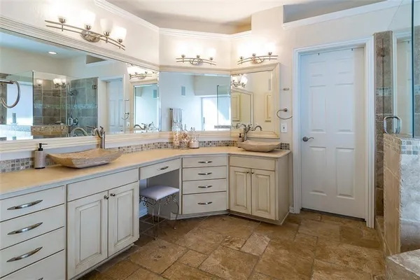 a spacious bathroom with a granite countertop sink mirror and a