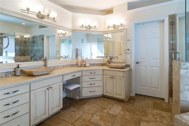 a spacious bathroom with a granite countertop sink mirror and a