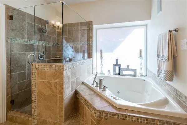 a bathroom with a tub and a shower