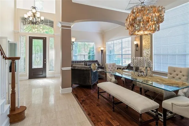 a living room with furniture and a chandelier