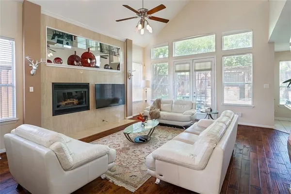 a living room with furniture two window and a fireplace
